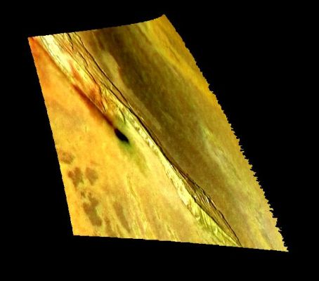 Zal Region on Io
This image shows one of many intriguing mountains on Jupiter's moon Io. The image was made by combining a recent high-resolution, black and white image with earlier low-resolution color data to provide a high-resolution, color view. NASA's Galileo spacecraft took both images.

The 240-kilometer (150-mile) long mountain in the image is south of the volcanic hot spot named Zal. The black and white version of this image was useful for showing the shape of the mountain and the small fans of debris piled against the base of its tall, steep cliffs. However, when colorized the relationship between different types of materials becomes apparent. For example, the bright, red material is believed to contain a compound of sulfur that forms when sulfur is boiled at a high temperature. Active eruptions of molten rock (lava) are the most likely source for the heat. Thus we see red sulfur where lava reaches the surface. Other sulfur compounds cover the yellow areas, and the black areas are fresh silicate lava that has not yet been coated by the yellow sulfurous materials. The green patches are still somewhat mysterious; they appear to form when red sulfur lands on warm lava and the two react in a manner that is still unknown.

In this image, it is clear that the red material has blown out of a long crack along the western side of the mountain. Lava has flowed from this crack and filled a depression (caldera). Some of the red sulfur close to the dark caldera appears to have been converted into green material. The fact that lava comes up along the faults that define the sides of the mountains provides important clues to how the mountains form and the state of the interior of Io. Scientists at the University of Arizona speculate that the formation of the mountains on Io may be related to plumes of hot material rising inside the fiery body of Io.

North is to the top and the setting sun is shining from the west. The image is centered at about 33 degrees north, 72 degrees west. The high-resolution image was taken on February 22, 2000 by NASA's Galileo spacecraft. The image was taken by the Galileo's onboard camera from a range of 33,500 kilometers (20,800 miles) and has a resolution of 335 meters (1,100 feet) per picture element. The color images were taken on July 3, 1999. They have resolutions of 1.3 kilometers (0.81 miles) per picture element and are illuminated from almost directly behind the spacecraft. They were taken at a distance of about 130,000 kilometers(81,000 miles) from Io.


Parole chiave: Jupiter's moons - Io