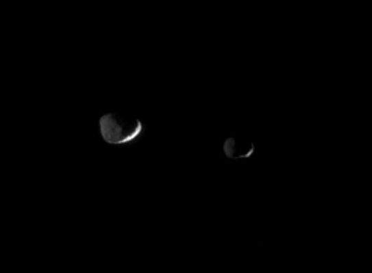 Brothers-in-arms, Brothers-in-light
Epimetheus (116 Km - about 72 miles - across, at right) and Janus (181 Km - about 113 miles - across, at left) are lit here by reflected "greylight" from Saturn. The Sun brightens only thin slivers of the moons' surfaces. 
A few large craters on Janus are visible in the dim light of Saturn. 

The image was taken in visible light with the Cassini spacecraft narrow-angle camera on Nov. 29, 2005 a distance of approximately 1,1 MKM  (about 700.000 miles) from both moons. Resolution in the original image was 7 Km (about 4 miles) per pixel. The image has been magnified by a factor of two and contrast-enhanced to aid visibility.
Parole chiave: Saturn's Moons - Janus and Epimetheus