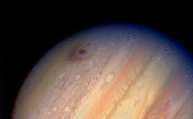 Jupiter in natural colors, after being struck by Shoemaker-Levy 9
This image of the giant planet Jupiter, by NASA's HST, reveals the impact sites of fragments "D" and "G" from Comet Shoemaker-Levy 9. 
The large feature was created by the impact of fragment "G" on July 18, 1994 at 3:28 a.m. EDT. It entered Jupiter's atmosphere from the south at a 45° angle and the resulting ejecta appears to have been thrown back along that direction. The smaller feature to the left of the fragment "G" impact site was created on July 17, 1994, at 7:45 a.m. EDT by the impact of fragment "D".
This image was taken 1h and 45' after fragment "G" impacted the Planet. The "G" impact has concentric rings around it, with a central dark spot that is about 2.500 Km in diameter. Such a dark spot is surrounded by a thin, dark, ring whose diameter is roughly 7.500 Km. 
Last (but not least...), the dark, thick, outermost ring's inner edge has a diameter of approx. 12.000 Km (the size of Earth...).
The impact sites are located in Jupiter Southern Hemisphere at a latitude of about 44°.
Parole chiave: Hubble Images - Jupiter