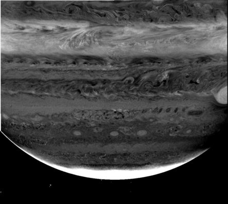 A "deep look" in the "deep clouds" of Jupiter
Finally, this is the combination of the 3 images taken from Cassini using the 3 different filters. 
This picture reveals cloud structures and movements at different depths in the atmosphere around Jupiter's South Pole. Cassini's cameras come equipped with filters that sample 3 wavelengths where Methane gas absorbs light. These are in the RED (619 nnmts) and in the NEAR-INFRARED (at 727 and 890 nnmts). Absorption in the 619 nnmts filter is weak. It is stronger in the 727 nnmts band and very strong in the 890 nnmts band where 90% of the light is absorbed by Methane gas. 
Light in the weakest band can penetrate the deepest into Jupiter's atmosphere. It is sensitive to the amount of cloud and haze down to the pressure of the water cloud (which lies at a depth where pressure is about 6 times the atmospheric pressure at sea level on the Earth). 
Light in the strongest methane band is absorbed at high altitude and is sensitive only to Ammonia cloud level and higher (with pressures less than about one-half of Earth's atmospheric pressure) and the middle methane band is sensitive to the ammonia and ammonium hydrosulfide cloud layers as deep as two times Earth's atmospheric pressure.
Parole chiave: Jupiter