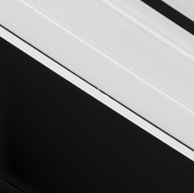 S/2005 S1: the "Keeler-Gap" Moon
Cassini's cameras were retargeted to capture the tiny Keeler Gap Moon S/2005 S1, visible at the center and first discovered by Cassini a few months ago. Waves raised in the gap edges by the Keeler moonlet's gravity are clearly visible here. Scientists can use the height of the waves to determine the little moon's mass. 
The Keeler moon is 7 Km (about 4,3 miles) across and orbits within its 42-km (about 26-mile) wide gap. The much larger Encke Gap (325 Km, or 200 miles wide) is seen here at the upper right (...). This image was taken in visible light with the Cassini spacecraft narrow-angle camera on Aug. 1, 2005, at a distance of approx. 853.000 Km (or about 530.000 miles) from Saturn. The image scale is 5 Km (3 miles) per pixel. The image has been contrast-enhanced and magnified by a factor of 3 to aid visibility.
Parole chiave: Saturn's Moons - S/2005 S1