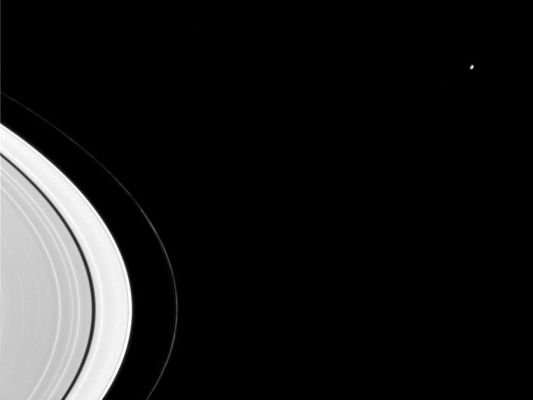 Mimas: the "Ring Master"
Caption NASA originale, tratta dal Planetary Photojournal:"Mimas, seen here beyond Saturn's rings, is a major sculptor of Saturn's rings. The 398-Km-wide moon not only maintains the Cassini Division (not seen here), a gap wide enough to be visible from Earth through a small telescope, but it is also responsible for two of the thin, bright bands visible in this image near the rings' center, interior to the dark Encke Gap. 
Knots in the thin, twisted F-Ring also are easily visible here. 
The image was taken in visible light with the Cassini spacecraft narrow angle camera on Sept. 7, 2004, at a distance of 8.8 MKMs from Mimas and at a Sun-Mimas-spacecraft - or phase - angle of 84 degrees. The image scale is 53 Km per pixel".

Parole chiave: Saturn's Moons - Mimas