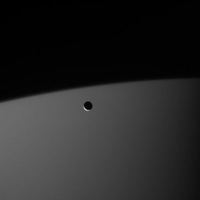 The King and I...
A small and battered reminder of the Solar System's violent youth, the ice moon Mimas hurtles around its gas giant parent, Saturn. 
With its "poor dimensions" (Mimas is only about 397 Km across), this little moon is dwarfed by the immensity of Saturn (the Ringed Gas Planet is more than 150 times as wide as Mimas). 
Mimas is seen here against the night side of Saturn and Saturn itself is faintly lit by sunlight reflecting off its Rings. 

The image was taken in visible light with the Cassini spacecraft narrow-angle camera on Jan. 20, 2006, at a distance of approx. 1,4 MKM (such as about 900,000 miles) from Mimas and at a Sun-Mimas-spacecraft, or phase, angle of 145°. Image scale is about 9 Km (approx. 5 miles) per pixel.
Parole chiave: Saturn's Moons - Mimas