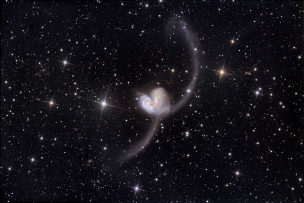 NGC 4038 and 4039: The "Antennae" Colliding Galaxies
"...Ambition is the last resort of failure..."

(Oscar Wilde)

Caption NASA originale:"Some 60 million LY away in the southerly constellation Corvus, two large galaxies have collided. But stars in the two galaxies - NGC 4038 and NGC 4039 - don't collide in the course of the ponderous, billion year or so long event. Instead, their large clouds of molecular gas and dust do, triggering furious episodes of star formation. 
Spanning about 500.000 LY, this stunning view reveals new star clusters and matter flung far from the scene of the accident by gravitational tidal forces. Of course, the visual appearance of the far-flung arcing structures gives the galaxy pair their popular name - "The Antennae". Recorded in this deep image of the region at the tip of the upper arc is a tidal dwarf galaxy NGC 4038S, formed in the cosmic debris".
Parole chiave: From Earth Pictures - Professional Pictures