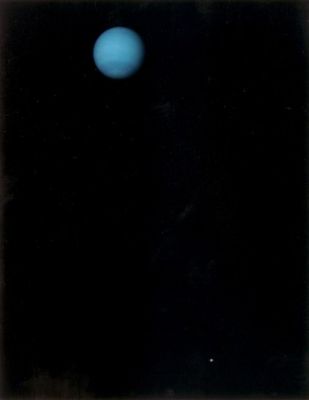 Neptune and Triton
Caption NASA originale:"This image was returned by the Voyager 2 spacecraft on July 3, 1989, when it was 76 MKM from Neptune. The planet and its largest satellite, Triton, are captured in the field of view of Voyager's narrow-angle camera through violet, clear and orange filters. Triton appears in the lower right corner at about 5 o'clock relative to Neptune. 
Recent measurements from Voyager images show Triton to be between 1.400 and 1.800 Km in radius with a surface that is about as bright as freshly fallen snow". 
Parole chiave: Neptune and Triton
