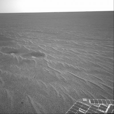 Outside Eagle Crater: small Side-Winders, back-shell & parachute - Sol 58
Caption NASA originale:"This image from Opportunity is part of the first set of pictures that was returned to Earth after the Rover exited Eagle Crater. Scientists are busy analyzing Opportunity's new view of the plains of Meridiani Planum. The plentiful ripples are a clear indication that wind is the primary geologic process currently in effect on the plains. On the left of the image are two depressions - each about 1 mt across - that feature bright spots in their centers. One possibility is that the bright material is similar in composition to the rocks in Eagle Crater's outcrop and the surrounding darker material is what's referred to as "lag deposit," or erosional remnants that are much harder and more difficult to wear away". 

Nota: alcuni Ricercatori hanno pensato che quelle 2 depressioni con 'qualcosa' che emerge dal loro centro sìano due affioramenti di acqua. La NASA, al riguardo, oltre a quello che avete letto nella "Caption", non ha - per quanto ne sappiamo - mai aggiunto altro.
Parole chiave: Mars dunes - Side Winders
