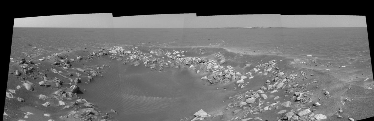 Fram Crater: a small crater on the way to Endurance - Sol 85
Un piccolo cratere, di fatto molto simile al Viking Crater (il quale verrà incrociato da Opportunity una volta fuori da Endurance e sulla via di Erebus e Victoria), si trova sulla strada del Rover mentre si dirige verso quella che sarà la sua 'casa' per oltre 6 mesi. Suggestivo lo sfondo, con Endurance Crater già ben visibile a Dx e molto interessante l'interno di questo piccolo cratere: si possono intravedere, infatti, delle fitte - ma sottili e basse - 'onde di sabbia' sul tipo di quelle che vedremo all'interno di Endurance e di Viking stessi.

Questo il commento NASA all'immagine:"The camera acquired the images at approx. 14:28 Local Solar Time - such as 06:30 a.m. Pacific Daylight Time - on April 20, 2004. 
The view is from the Rover's new location, a region dubbed 'Fram Crater' located some 450 mt (approx. 0,3 mi) from Eagle Crater and roughly 250 mt (approx. 820 feet) from Endurance Crater".
Parole chiave: Mars craters
