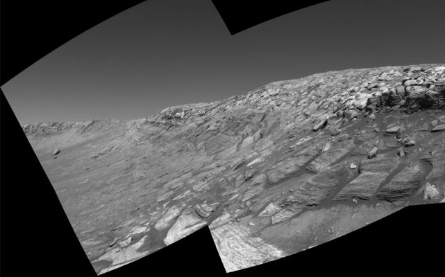 Looking for a "way out"... (1) - Sol 297
Caption NASA originale:"As NASA's Mars Exploration Rover Opportunity was making its way back toward its original entry path into "Endurance Crater," scientists and engineers spotted what they hoped might be a shortcut for climbing out of the crater. The possible exit path, pictured on the far right of this image where the outcrop is punctuated, was eventually deemed too hazardous for the rover to attempt. Opportunity would have had to cross terrain with a slope of 28 degrees and face a tall rock outcropping very close to the exit chute opening which, itself, is too narrow for the rover to pass. This view combines several frames taken by the rover's navigation camera during Opportunity's 297th sol on Mars (Nov. 24, 2004). It is presented in a cylindrical projection with geometric seam correction. The location from which the image was taken has been designated as Opportunity's Site 38, Position 97". 
Parole chiave: Endurance Crater - The edge