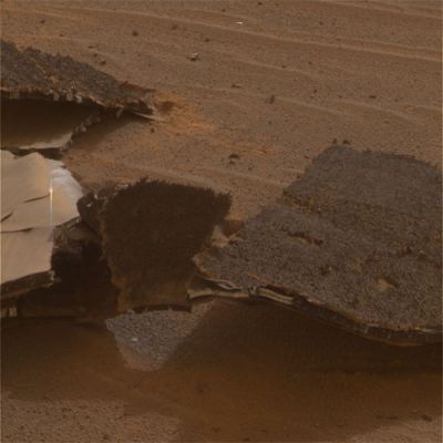 The broken "Heat-Shield", from very close! - Sol 331 (true colors; credits: NASA)
Caption NASA originale"This image from NASA's Mars Exploration Rover Opportunity features an up-close view of the flank piece of the Rover's broken Heat-Shield. 
The rover spent 36 Sols investigating how the severe heating during entry through the atmosphere affected the Heat-Shield. The most obvious is the fact that the Heat-Shield inverted upon impact. Overall, engineers were interested in evaluating the performance of the Heat-Shield's Thermal Protection System. 
This is the the PanCam Team's BEST current attempt at generating a "true color" view of what this scene would look like if viewed by a human on Mars. It was generated from a mathematical combination of six calibrated, left-eye panoramic camera images acquired around 15:07 MLT on Opportunity's Sol 331 (Dec. 28, 2004) using filters ranging in wavelengths from 430 to 750 nanometers".
Parole chiave: The Heat-Shield