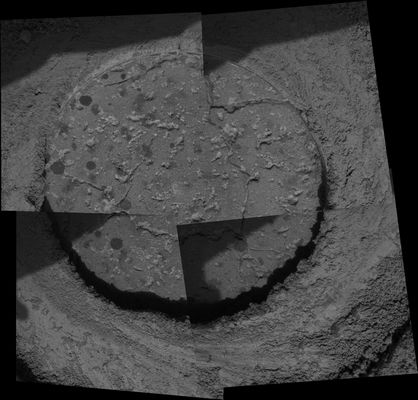 Inside Martian Rocks - Sol 546
Proving once again that Mars is a complex and fascinating place, NASA's Opportunity Rover has entered new terrain and is providing scientists with more discoveries and puzzles to solve. "One of the things we've been wondering" - said principal investigator Steve Squyres - "is whether the rounded concretions we call 'blueberries' are the same everywhere. It turns out they're not. The berries are more numerous here, and some seem to be smaller than any we've ever seen."
This MI of a drill hole cut into a martian rock nicknamed "Ice Cream" by the Rover's RAT shows cross sections of round concretions 1 to 2 mm (0,04 to 0,08") wide. Science team members are debating whether the grayish-looking smudges that are not as round are concretions or some other feature. Opportunity took this mosaic of images with its MI on Sol 546 (Aug. 6, 2005). The area shown is approx. 6 cm (about 2,4") wide.

Opportunity is now almost 4 Km South of Endurance Crater, where the Rover spent from May through December of 2004.
Parole chiave: Microscopic Imager