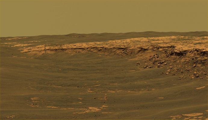Payson Outcrop (1) - Sol 744
The PanCam aboard NASA's MER Opportunity acquired this panorama of the "Payson" outcrop on the western edge of Erebus Crater during Opportunity's Sol 744 (Feb. 26, 2006). From this vicinity at the northern end of the outcrop, layered rocks are observed in the crater wall, which is about 1 mt (3,3 feet) thick. The view also shows rocks disrupted by the crater-forming impact event and subjected to erosion over time. 
To the left of the outcrop, a flat, thin layer of spherule-rich soils overlies more outcrop materials. The Rover is currently traveling down this road and observing the approx. 25-meter (82-foot) length of the outcrop prior to departing Erebus crater. 

The panorama camera took 28 separate exposures of this scene, using four different filters. The resulting panorama covers about 90° of terrain around the Rover. This approx. true-color rendering was made using the camera's 753-, 535- and 423-nnmt filters. Image-to-image seams have been eliminated from the sky portion of the mosaic to better simulate the vista a person standing on Mars would see.
Parole chiave: Erebus' Rim Area