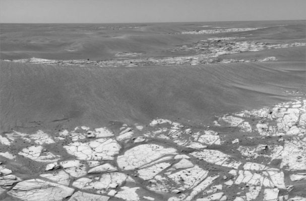 Looking towards Victoria Crater (1) - Sol 817
Caption NASA originale:"This composite of 3 images from the NavCam shows the view from NASA's MER Opportunity toward the South-East, in the direction of Victoria Crater, on the Rover's 817th Martian day, or Sol (such as May 12, 2006). To reach Victoria Crater, still about 1100 meters (2/3ds of a mile) from this location, the Rover must navigate among the large ripples visible on the left and ahead in the distance. 

On this Sol, Opportunity was preparing to deploy its RA instrument suite to analyze a rock on the outcrop pavement. At upper right (frame 2) is a small depression that was the target of further imaging on Soles 825 and 826 (May 20 and 21, 2006)".
Parole chiave: Mars Panorama - Dunes, Ripples and Outcrops - Meridiani Planum