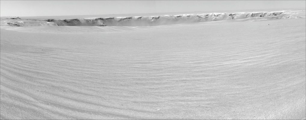 Victoria Crater, from 20 mt - Sol 950
Caption NASA originale:"A drive of about 30 mt (about 100 feet) on the 950th Sol of MER Opportunity's exploration of Mars' Meridiani Planum Region (Sept. 25, 2006) brought the NASA Rover to within about 20 mt (about 66 feet) of the rim of Victoria Crater. (...) The scalloped shape of the Crater is visible on the left edge. Due to a small dune or ripple close to the nearest part of the rim, the scientists and engineers on the rover team planned on Sol 951 to drive to the right of the ripple, but not quite all the way to the rim, then to proceed to the rim the following Sol. The image is presented in cylindrical projection with geometric seam correction".
Parole chiave: Victoria Crater