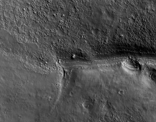 The "First Frame" from MRO
This view shows a full-resolution portion of the first image of Mars taken by the High Resolution Imaging Science Experiment camera (HiRISE) on NASA's Mars Reconnaissance Orbiter. The spacecraft, launched Aug. 12, 2005, began orbiting Mars on March 10, 2006. The image is of an area in Mars' mid-latitude Southern Highlands. 

HiRISE took this first test image from orbit on March 24, 2006, from an altitude of 2.489 Km (about 1.547 miles), achieving a resolution of 2,49 mt (98" - inches) per pixel, or picture element. The smallest objects of discernable shape are about 3 pixels across. An image acquired at this latitude during the Mars Reconnaissance Orbiter's main science phase, beginning in fall 2006, would be taken from an altitude of about 280 Km (approx. 174 miles) and have a resolution of 28 cm (11") per pixel. 
This view covers an area about 4,5 by 2,1 Km (about 1,6 by 1,3 miles).
The quality of this test image is spectacular, with no hint to the eye of any smear or blurring. A high signal-to-noise ratio reveals fine details even in the shadows. 
Parole chiave: Mars from orbit - Southern Highlands