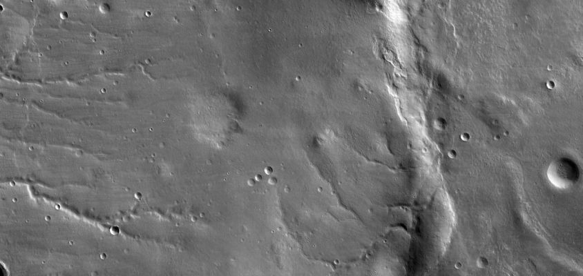 The "First Frame" from MRO (detail mgnf)
The scene covers an area 49,8 Km (about 30,9 mi) wide and 23,6 Km (about 11,7 mi) high, of landscape typical of Mars' mid-latitude Southern Highlands. The location is 34° South Latitude, 305° East Longitude. An old, muted crater lies at the middle of the scene, with sets of channels to the left and right. Superimposed on parts of this terrain is a much younger, layered mantle of debris. The debris mantle is smooth in places but rough in other areas where it may have partially sublimated. This suggests that the debris mantle is (or was) rich in volatiles such as ices of water, CO2 or both. Also superimposed on the landscape are many small sharp-rimmed impact craters and wind-blown dunes. This image illustrates processes that may have involved water both on ancient Mars (channels and eroded craters) and much more recently in Mars' history (volatile-rich debris mantle). The radiometric and geometric processing of this image is very preliminary. In particular there are mismatches visible at full resolution along the seams between the 10 side-by-side images from separate CCDs (charge-coupled devices, which are electronic optical sensors). 
Parole chiave: Mars from orbit - Southern Highlands