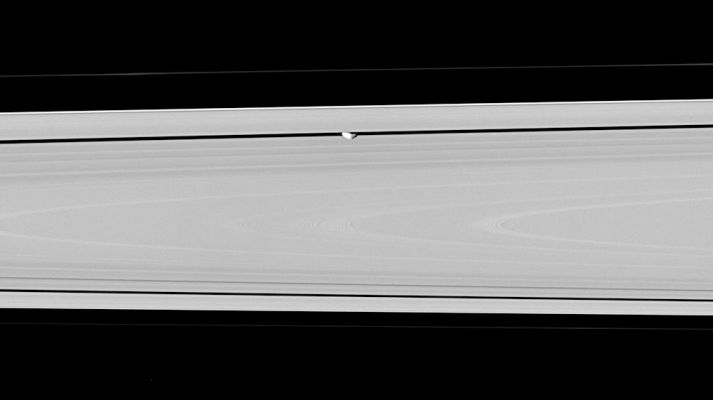 Inside "Encke"...
Caption NASA originale:"Hiding within the Encke Gap is the small moon Pan, partly in shadow and party cut off by the outer A-Ring in this view. Similar to Atlas, Pan appears to have a slight ridge around its middle; and like Atlas, Pan's orbit also coincides with a faint ringlet. Pan is 26 Km(about 16 miles) across. 

The image was taken in visible light with the Cassini spacecraft narrow-angle camera on June 30, 2006 at a distance of approximately 269.000 Km (such as about 167.000 miles) from Pan. Image scale is roughly 2 Km(approx. 5.259 feet) per pixel".
Parole chiave: Saturn's Moons - Pan