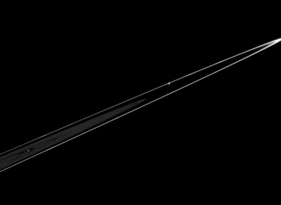 Pandora at the edge of the Rings
Caption NASA originale:"Pandora is seen in this dramatic view, orbiting just beyond the outer edge of Saturn's F-Ring. Several bright areas are visible within the F-Ring. In the main Rings, the Keeler gap and the Encke gap - with a bright ringlet - are also visible. Pandora is 84 Km (approx. 52 miles) across. The image was taken in visible light with the Cassini spacecraft narrow-angle camera on Feb. 18, 2005, at a distance of approximately 1,2 MKM (approx. 746.000 miles) from Pandora and at a Sun-Pandora-spacecraft angle of 108°. The image scale is 7 Km per pixel".
Parole chiave: Saturn's Moons - Pandora