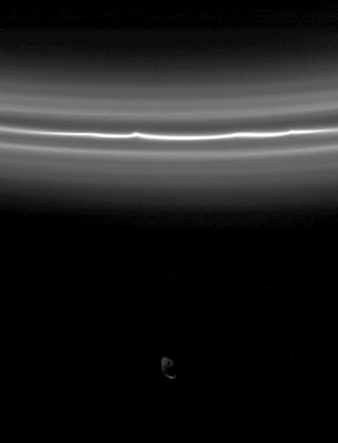 Pandora
Original caption:"Saturn's moon Pandora is almost overwhelmed by the brightness of the F-Ring in this view. The F-Ring's bright core displays kinks and is flanked by fainter ringlets. Imaging scientists recently determined these fainter ringlets to be a single spiral ring that winds around the Planet. Pandora is faintly lit by "Saturnshine," or reflected light from the planet, and few features can be seen here. This image was acquired by Cassini exactly three hours after the spacecraft took the image seen in previous PIA07601, which showed Prometheus interior to the F-Ring. 
The image was taken in visible light with the Cassini spacecraft narrow-angle camera on Aug. 21, 2005, at a distance of appx. 583.000 Km from Saturn and at a high Sun-Saturn-spacecraft angle of 136°. Resolution is about 3 Km per pixel".

Nota: osservate il frame PIA07530 e poi confrontate le due immagini di Pandora. A noi sembra che ci sia una "profonda" differenza e che il corpo celeste ripreso nei due frames NON sia lo stesso.
Parole chiave: Saturn's Moons - Pandora