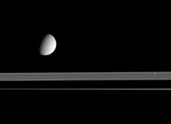 Pandora and Dione
Original caption:"This view looks up toward the sunlit side of Saturn's rings, as Dione and Pandora trundle by. The moons are on the near side of the Rings and the Planet's shadow stretches across the Rings in the background.

The Cassini spacecraft took this image in visible light with its narrow-angle camera on Sept. 16, 2005, at a distance of approx. 2,4 MKM (such as roughly 1,5 MMs) from Saturn. The image scale is of about 12 Km (7 miles) per pixel on Dione".
Parole chiave: Saturn's Moons - Pandora and Dione