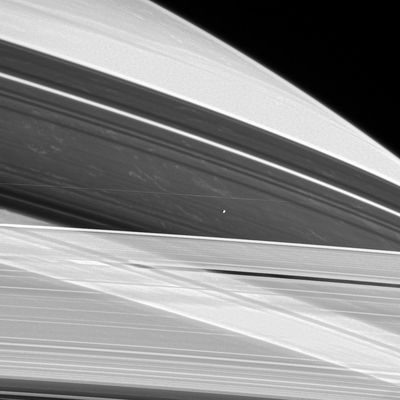 Prometheus
Caption NASA originale:"Saturn's shepherd moon Prometheus hovers between the A and F-Rings as if suspended on an invisible thread, while bright clouds drift in Saturn's atmosphere approximately 130.000 Km(such as about 81.000 miles) beyond. It is noteworthy that such clouds are visible here in the shadows cast by the Rings. 

The image was taken in visible light with the Cassini spacecraft narrow-angle camera on June 3, 2005, at a distance of approximately 2,1 MKM (1,3 MMs) from Saturn. The image scale is 13 Km (approx. 8 miles) per pixel. This view was processed to enhance fine details".
Parole chiave: Saturn's Moons - Prometheus