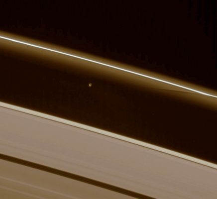 Prometheus' trail
Caption NASA:"Prometheus interacts gravitationally with the inner flanking ringlets of the F-Ring, creating dark channels as it passes. 
This image was taken in a complete azimuthal scan of the Rings, during which Cassini followed Prometheus (102 Km, or 63 miles across) around the Rings for one complete orbit, or about 14 hours. This view looks toward the unlit side of the Rings from about 41° above the Ring-Plane. The moon is partly lit by Sunlight (at left) and elsewhere lit by reflected light from Saturn. 

The image was taken in visible light with the Cassini spacecraft narrow-angle camera on Nov. 23, 2006 at a distance of approx. 1,5 MKM (900.000 miles) from Prometheus and at a Sun-Prometheus-spacecraft, or phase, angle of 152°. Image scale is roughly 9 Km (a little more than 5 miles) per pixel".
Parole chiave: Saturn's Moons - Prometheus