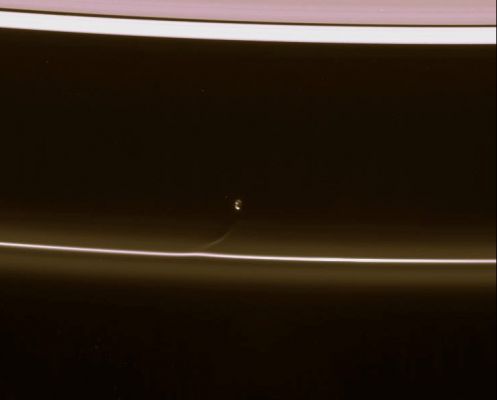 Restless Prometheus...
Caption NASA:"Prometheus draws a fresh streamer of material from the F-Ring as it passes the Ring's interior edge. The streamer will continuously shear out as it orbits the planet, becoming more elongated and increasingly aligned with the F-Ring with time. 
A single large crater is the principle feature visible on Prometheus (102 Km, or about 63 miles across) in this view. The moon is lit partly by bright Sunlight and partly by reflected light from Saturn. 

This view looks toward the unlit side of the rings from about 57° above the Ring-Plane. 

The image was taken in visible light with the Cassini spacecraft narrow-angle camera on Feb. 11, 2007 at a distance of approx. 1,7 MKM (about 1,1 MMs) from Prometheus and at a Sun-Prometheus-spacecraft, or phase, angle of 130°. 
Image scale is roughly 10 Km (about 6 miles) per pixel".
Parole chiave: Saturn's Moons - Prometheus