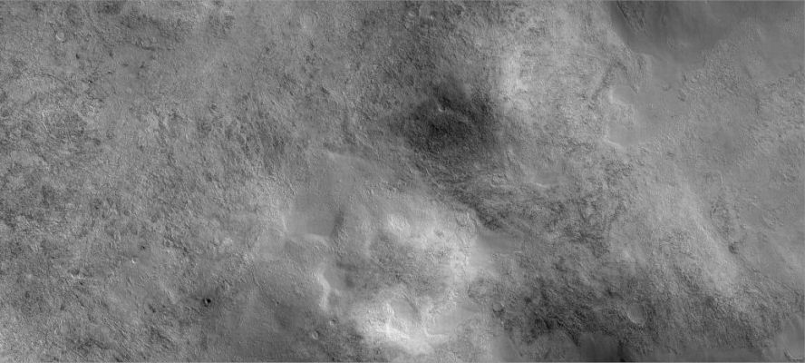 In the vicinities of Halley Crater (1)
This image shows a landscape West of Mars' Argyre impact basin and North-East of Halley Crater. The large but faint circular feature near the center of the image is an unnamed impact crater about 7,5 Km (about 4,7 miles) in diameter. It has been all but erased by geological (and probably ice-related) processes. In fact, the majority of impact craters in this image have been modified from their original shapes, some undoubtedly beyond recognition. Only a few small craters remain pristine. The most prevalent surface type in this image is rough, dissected terrain, which is characterized by a complex pattern of knobs, pits, ridges and valleys. In places the rough terrain has been covered by a younger material that appears flat, smooth and nearly featureless. The smooth material may have been emplaced as muddy or icy debris. It filled low-lying areas (most notably craters) and surrounded higher features, preserving islands of rough terrain. Wind-formed dunes have formed atop some of the smooth material and diagonal streaks on the right side of the image may be due to the winds. Images such as this show the importance of water (liquid and/or ice), wind, and impacts in shaping the surface of Mars.
Parole chiave: Mars from orbit - Craters - Halley Crater