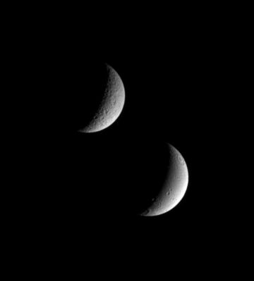 Spheres...
Original caption:"Saturn's sibling moons, Rhea and Dione, pose for the Cassini spacecraft in this view. 
Even at this distance, it is easy to see that Dione (below) appears to have been geologically active in the more recent past, compared to Rhea. 
Dione's smoother surface and linear depressions mark a contrast with Rhea's cratered terrain. 
Sunlit terrain seen on Rhea (1.528 Km, or 949 miles across) is on the moon's Saturn-Facing Hemisphere. Lit terrain on Dione (1.126 Km, or 700 miles across) is on that moon's Leading Hemisphere. North is up. 

The image was taken in visible light with the Cassini spacecraft narrow-angle camera on Nov. 1, 2005, at a distance of approx. 1,8 MKM (about 1,1 MMs) from Rhea and 1,2 MKM (approx. 800.000 miles) from Dione. The image scale is 11 Km (about 7 miles) per pixel on Rhea and 7 Km (about 4 miles) per pixel on Dione".
Parole chiave: Saturn's Moons - Rhea and Dione