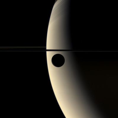 Rhea and Saturn in natural colors
Caption NASA originale:"The slim crescent of the moon Rhea glides silently onto the featureless, golden face of Saturn. In an interplay of contrast and shadow, the moon goes dark against the Planet, and then its crescent suddenly brightens as it slips in front of Saturn's night side. 
This view looks down onto the unlit side of Saturns Rings, which cast soft, linear shadows onto the Planet's Northern Hemisphere. 

The image was acquired by the Cassini spacecraft wide-angle camera on March 21, 2006, at a distance of approx. 221.000 Km (about 137.000 miles) from Rhea. The image scale is approx. 13 Km (about 8 miles) per pixel".
Parole chiave: Saturn's Moons - Rhea