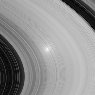 The "Opposition Effect"
Caption NASA originale:"The "opposition effect" can be seen in this image of Saturn's B ring. The bright spot occurs where the angle between the spacecraft, the Sun and the Rings is near zero. 
Studies of the Opposition Effect on Saturn's Rings may help scientists constrain some of the properties of the Ring particles, such as their sizes and spatial distribution. 
The image was taken in visible light with the Cassini spacecraft wide-angle camera on June 26, 2005, at a distance of approximately 478.000 Km (about 297.000 miles) from Saturn. The image scale is 3 Km (about 2 miles) per pixel".
Parole chiave: Saturn