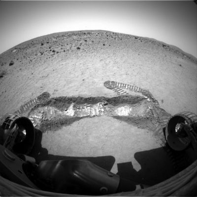The "trench" inside Laguna Hollow
Caption NASA originale:"A view from the Front Haz-Cam of NASA's Spirit rover on its 47th Sol, shows a trench excavated by the Rover's left front wheel within the "Laguna Hollow" area. The trench - dubbed Road Cut, is 7 cm (3") deep. The soil at this location is more cohesive than the material where Spirit's twin, Opportunity, dug its first trench at Meridiani Planum. 
Spirit made 11 back-and-forth passes to dig this trench, and still did not produce as deep a hole as Opportunity dug in 6 passes. 
Scientists and engineers plan to begin up-close inspection of the soil in this trench on Sol 48, by placing the MI on the floor and the walls before conducting readings with the Rover's Moessbauer and Alpha Particle X-Ray Spectrometers on some of the same points".
Parole chiave: Mars rocks, sand and debris
