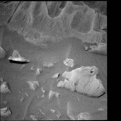 Closing-up on Mazatzal - Sol 77
Caption NASA originale:"This b/w PanCam image of the rock called Mazatzal (at the top of the image) was taken by the MER Spirit on Sol 77 (March 2, 2004). It reveals some interesting features on this future RAT target, including variants in tone, a "sugary surface" texture and scalloped areas where parts of the rock seem to have been worn away. Mazatzal's uniqueness is made even more obvious when it is compared to the more typical, basaltic rock in the lower right of the image".
Parole chiave: Mars rocks, sand and debris
