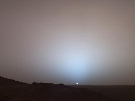 Sunset on Mars - Sol 489
On May 19th, 2005, NASA's MER Spirit captured this stunning view as the Sun sank below the rim of Gusev Crater on Mars. This PanCam mosaic was taken around 18:07 MLT of the Rover's 489th Sol. Spirit was commanded to stay awake briefly after sending that Sol's data to the Mars Odyssey orbiter just before sunset. This small panorama of the western sky was obtained using PanCam's 750, 530 and 430-nnmts color filters. This filter combination allows false color images to be generated that are similar to what a human would see, but with the colors slightly exaggerated. In this image, the bluish glow in the sky above the Sun would be visible to us if we were there, but an artifact of the Pancam's infrared imaging capabilities is that with this filter combination the redness of the sky farther from the sunset is exaggerated compared to the daytime colors of the martian sky. Because Mars is farther from the Sun than the Earth is, the Sun appears only about two-thirds the size that it appears in a sunset seen from the Earth. The terrain in the foreground is the rock outcrop "Jibsheet", a feature that Spirit has been investigating for several weeks (rover tracks are dimly visible leading up to "Jibsheet"). The floor of Gusev crater is visible in the distance, and the Sun is setting behind the wall of Gusev some 80 km (50 miles) in the distance.
Parole chiave: Postcards from Mars