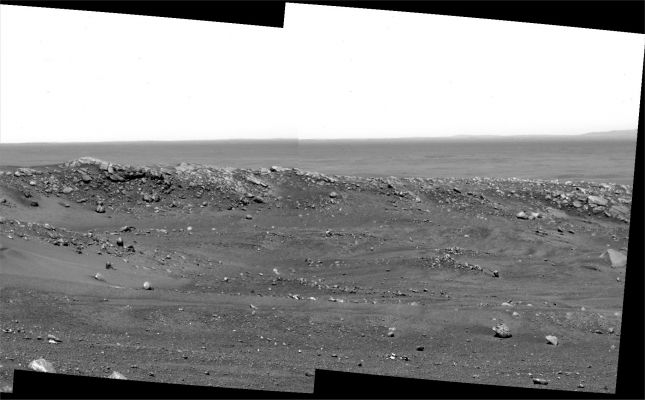 The "Sand-Strewn" Summit of Husband Hill (2) - Sol 603
Original caption:"The largest light-colored rock in the foreground is nicknamed Whittaker while the cliff beyond it and slightly to the left is Tenzing. The highest rock on the ridge ahead has been dubbed Hillary. Science team members selected the nicknames in honor of the earliest climbers to scale Mount Everest on Earth.

This view covers approximately 50° of the compass from left to right. It is a mosaic assembled from frames Spirit took with the PanCam on Sol 603 (Sept. 13, 2005). It was taken through a blue (430-nanometer) filter and is presented as a cylindrical projection". 
Parole chiave: Mars Panorama - Husband Hill - Summit