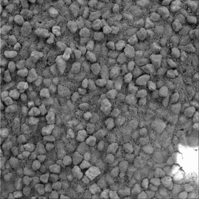 Sand grains of the Summit - Sol 607
A basic tenet of Sedimentology is that the farther a piece of rock travels from its source, the smaller and rounder in shape it becomes as the materials suffer impacts with other grains during transport by wind or water. Grains that have not traveled as far are more angular and less rounded. A comparison of frames taken by the MI on Spirit suggests that sand that has accumulated in drifts on the plains of Gusev Crater traveled farther from the source rock than similar sand grains in the hills inside Gusev. In a MI frame taken on the plains of Gusev Crater (see PIA05288), sand deposits were made up of rounded grains, in contrast with this recent image of a sand drift near the top of Husband Hill that shows poorly sorted, more angular grains of sand (...). The photo covers an area 3 cm across. The scale of the image (31 microns/pixel) allows features as small as 0,1 mm to be resolved.

N.B.: sono nelle ultime 2 righe i "Dati Contingenti" sui MI frames che la NASA non fornisce (praticamente) MAI...
Parole chiave: Microscopic Imager - Mars debris