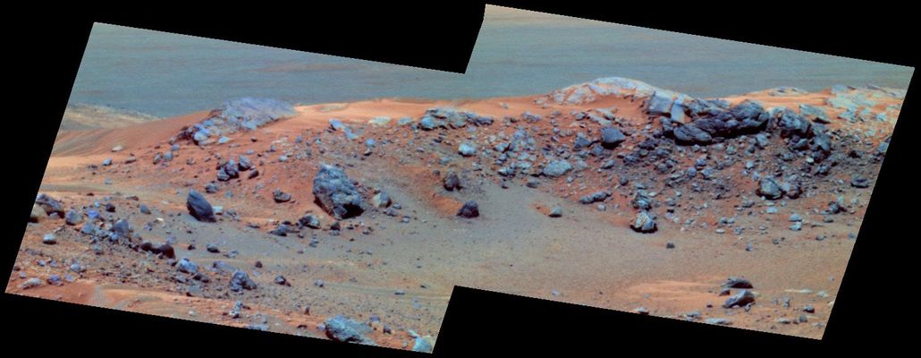 "Hillary" and "Tenzing" outcrops - Sol 608
NASA's MER Spirit will not plant a flag, as did Sir Edmund Hillary when he scaled Mount Everest on Earth, when the Rover reaches the hilltop outcrop shown here, which scientists have nicknamed in honor of Hillary. But Spirit will send images and other scientific data across the millions of miles that separate Earth from the distant planet where no human has yet set foot. This false-color view combines images that Spirit took with its PanCam during the Rover's 608th Sol (Sept. 18, 2005). The site is on top of 'Husband Hill' inside Gusev Crater. The component images were taken through the camera's 750-, 530- and 430-nnmt filters. 
The slightly lower outcrop to the left of 'Hillary' is nicknamed 'Tenzing.' The names recall the first humans - Hillary of New Zealand and Tenzing Norgay of Nepal - to reach the highest point on Earth, in 1953. 
Husband Hill rises 106 meters (348 feet) above the surrounding plains.
Parole chiave: The Summit of Husband Hill