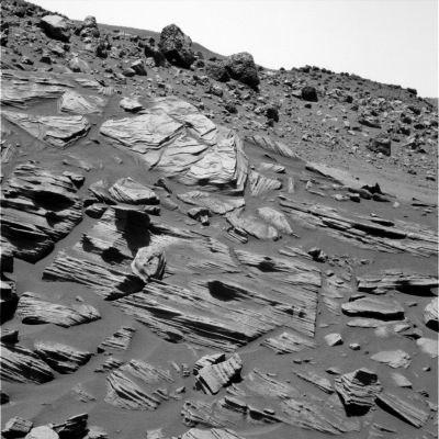 The "Burns Cliff of Gusev Crater" (1) - Sol 748
After several months of driving, Spirit finally reached the semicircular geologic feature dubbed "Home Plate" in Gusev Crater. Spirit first got a good view of Home Plate in late August, after cresting Husband Hill. 
After that, the Rover made scientific observations near the Summit before commencing an ambitious drive of 848 mt (about 2.782 feet, a little more than half a mile) in 94 Soles, to get to Home Plate. Spirit is now studying a rock target called "Barnhill" just below the tabletop-like surface of Home Plate using instruments on the Rover's RA. Science Team members have begun calling Home Plate the "Burns Cliff of Gusev" because of its layered appearance and steep slopes, which is reminiscent of, but smaller than, Endurance Crater, explored by Spirit's twin, Opportunity, on the opposite side of Mars in 2004.
Parole chiave: Unusual surface feature - Home Plate Area