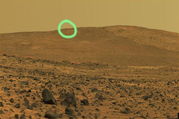 Home Plate: almost true colors and HR (2) - Sol 758
The limited spatial coverage of this panorama is the result of steadily decreasing power available to the Rover for science activities as the Martian Winter arrives and the Sun traces a lower path across the sky. The Rover Team anticipates that the north-facing slopes of McCool Hill should sufficiently tilt the Rover's solar panels toward the Sun to allow Spirit to survive the winter. 
The view covers about 230° of terrain around the Rover. Spirit's PanCam took 72 separate images of this scene with 4 different filters. This is an approximately true-color rendering using the Pancam's 75-, 535- and 432-nanometer filters. Image-to-image seams have been eliminated from the sky portion of the mosaic to better simulate the vista a person standing on Mars would see.

Cerchiatura Verde: non è un semplice difetto dell'incollatura fra le diverse fotografie. C'è effettivamente qualcosa di sfumato (ed in parte cancellato, ci sembra), quasi sul ciglio di McCool Hill.
Parole chiave: Mars Panorama - Home Plate Area