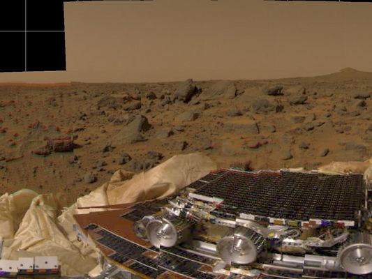 Color Panorama: Sol 1
Original caption:"This picture from Mars Pathfinder was taken at 9:30 AM in the martian morning or MLT (such as 14:30 PDT --> Pacific Daylight Time), after the Spacecraft landed on July 4, 1997. The picture shows the Sojourner Rover perched on 1 of 3 solar panels. The (mini)Rover is 65 cm (about 26") long by 18 cm (7") tall; each of its wheels is about 13 cm (5") high. The white material to the left of the front of the Rover is part of the airbag system used to cushion the landing.
Many rocks of different of different sizes can be seen in a background of reddish soil. The landing site is in the mouth of an ancient channel carved by water. The rocks may be primarily flood debris. The horizon is seen towards the top of the picture. The light brown hue of the sky results from suspended dust".
Parole chiave: Mars Panorama