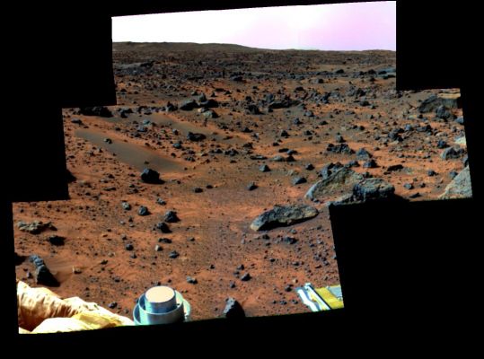 Boulder Field - Sol 13
This enhanced color image mosaic of the area south of the lander was made using images acquired in the mid-morning of Sol 13 by the IMP camera as part of the Super-Pan data set.
At each camera frame position, a Super-Pan image contains 15 frames (6 frames for 3-color stereo and 9 more individual narrow color bands). This mammoth color and stereo data set will be used to derive high quality topographic maps of the surface and detailed shapes of rocks and other surface features, and to map subtle chemical, mineralogical, and textural variations on rocks and soils. Red, green, and blue filter images from the right eye were combined to simulate slightly amplified natural color. The rocks Squid, Ender, Hassock, and a portion of Wedge are visible in the center-right portion of the mosaic. Mermaid Dune and Bosco rock are visible in the middle-left. The foreground contains portions of the airbags and the top of the low-gain antenna on the lander. 
The rim of the impact crater "Big Crater" is visible in the upper-left on the horizon.
Parole chiave: Mars rocks, sand and debris