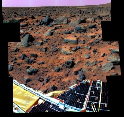 Rock Garden - Sol 32 (Enhanced Natural Colors; credits: NASA/JPL)
This enhanced color image mosaic of the Rock Garden area west of the lander was made using images acquired in the mid-morning of Sol 32 by the IMP camera as part of the Super-Pan data set.
At each camera frame position, a Super-Pan image contains 15 frames (6 frames for 3-color stereo and 9 more individual narrow color bands). This mammoth color and stereo data set will be used to derive high quality topographic maps of the surface and detailed shapes of rocks and other surface features, and to map subtle chemical, mineralogical, and textural variations on rocks and soils. Red, green, and blue filter images from the right eye were combined to simulate slightly amplified natural color. The "bookshelf" rocks visible in the background include Shark, Half-Dome, Moe and Stimpy. The Rover Soujourner completed imaging and APXS measurements of these rocks on Sol 71. Small rocks below and to the right of Flat Top appear to have been moved and/or pushed into the soil, probably by the spacecraft during landing. A portion of South Peak is visible in the upper right corner of the mosaic. One of the solar-panel-covered lander petals and the forward rover ramp are visible in the foreground.
Parole chiave: Mars rocks, sand and debris - Boulder Field