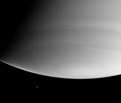Saturn and Enceladus (in ultra-violet)
Caption NASA originale:"Looking beyond Saturn's south pole, this was the Cassini spacecraft's view of the distant, icy moon, Enceladus on July 28, 2004. The planet itself shows few obvious features at these ultraviolet wavelengths, due to scattering of light by molecules of the gases high in the atmosphere. Enceladus is 499 Km wide. 
The image was taken with the Cassini spacecraft narrow angle camera at a distance of 7.4 MKM from Saturn through a filter sensitive to ultraviolet wavelengths of light. The image scale is 44 Km per pixel of Saturn".
Parole chiave: Saturn and Company