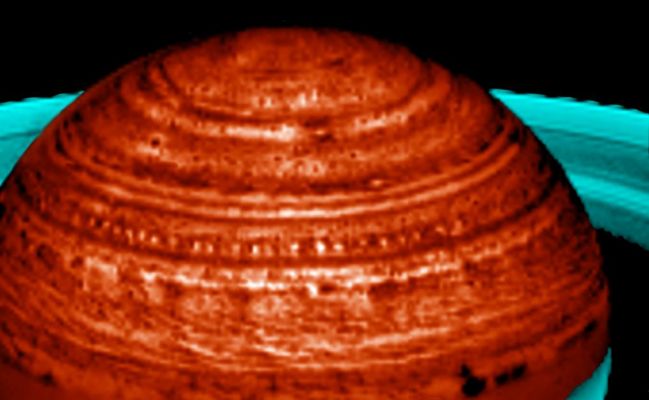 Infrared Saturn
In this image, Saturn's fascinating meteorology manifests itself in a "string of pearls" formation, spanning over 60.000 Km (about 37.000 miles). Seen in new images acquired by Cassini's VIMS (Visual and Infrared Mapping Spectrometer) and lit from below by Saturn's internal thermal glow, the bright "pearls" are actually clearings in Saturn's deep cloud system. More than two dozen occur at 40° North Latitude. Each clearing follows another at a regular spacing of some 3,5° in Longitude. 

This is the first time such a regular and extensive train of cloud-clearings has been observed. The regularity indicates that they may be a manifestation of a large planetary wave. Scientists plan to take more observations of this phenomenon over the next few years to try to understand Saturn's deep circulation systems and meteorology. This image was taken on April 27, 2006.
Parole chiave: Saturn - Upper Atmosphere
