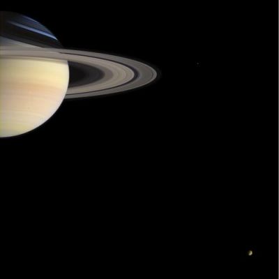 Saturn, Titan and Mimas in real colors
Caption NASA originale:"From its station nearly 1,2 BKMs (or 746 MMs) from Earth, the stalwart Cassini spacecraft sends holiday greetings to Earth with this lovely color portrait of Saturn and two of its moons. This color portrait serves as reminder of the Saturnian places we have already seen and the promise of future discovery at Titan when the European Space Agency's Huygens probe arrives at Titan on Jan. 14, 2005. A grayish, oval-shaped storm is visible in Saturn's southern hemisphere and is easily 475 Km across - the size of some hurricanes on Earth. Titan is visible near lower right with its thick, orange-colored atmosphere, and faint Mimas (398 Km across) appears just right of the rings' outer edge. Images taken in the red, green and blue filters with the Cassini spacecraft wide angle camera on Dec. 14, 2004, were combined to create this color view at a distance of approximately 719.000 Km from Saturn. The image scale is 43 Km (or 27 miles) per pixel".
Parole chiave: Saturn and Companions