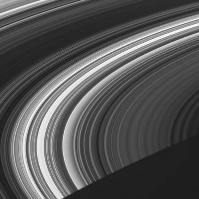 Rings in the Rings, both cut by the darkness...
Caption NASA originale:"This view shows the unlit face of Saturn's Rings, visible via scattered and transmitted light. In these views, dark regions represent gaps and areas of higher particle densities, while brighter regions are filled with less dense concentrations of ring particles. 
The dim right side of the image contains nearly the entire C-Ring. The brighter region in the middle is the inner B-Ring, while the darkest part represents the dense outer B-Ring. The Cassini Division and the innermost part of the A-Ring are at the upper-left. 
Saturn's shadow carves a dark triangle out of the lower right corner of this image. 
The image was taken in visible light with the Cassini spacecraft wide-angle camera on June 8, 2005, at a distance of approximately 433.000 Km (about 269.000 miles) from Saturn. The image scale is 22 Km (about 14 miles) per pixel".
Parole chiave: Saturn's Rings