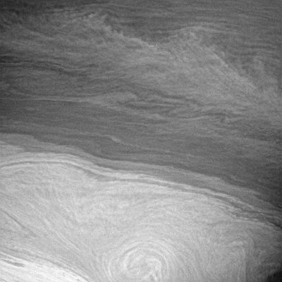 Saturn or Van Gogh?
Saturn's turbulent atmosphere is reminiscent of a Van Gogh painting in this view. However, unlike the famous impressionist painter, Cassini records the world precisely as it appears to the spacecraft's cameras. 
The feathery band that cuts across from the upper left corner to the right side of this scene has a chevron, or arrow, shape near the right. The center of the chevron is located at the latitude (about 28° South) of an eastward-flowing zonal jet in the atmosphere. Counter-flowing eastward and westward jets are the dominant dynamic features seen in the giant planet atmospheres. A chevron-shaped feature with the tip pointed East means that this is a local maximum in the eastward wind and a region of horizontal wind shear where clouds to the North and South of the jet are being swept back by the slower currents on the sides of the jet. 

The image was taken in visible light with the Cassini spacecraft narrow-angle camera on July 6, 2005, at a distance of approx. 2,5 MKM from Saturn using a filter sensitive to wavelengths of infrared light centered at 727 nanometers. The image scale is 14 kilometers (9 miles) per pixel.
Parole chiave: Saturn