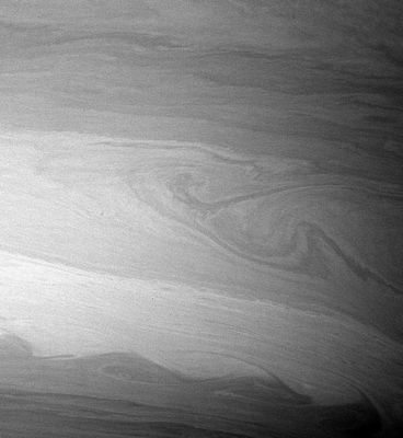 Saturnian Atmosphere: the "Cat's Eye"
Original caption:"During its time in orbit Cassini has already spotted many beautiful "Cat's Eye-shaped" patterns like the ones visible here. These patterns occur in places where the winds and the atmospheric density at one latitude are different from those at another latitude. 
The opposing East-West flowing cloud bands are the dominant patterns seen here and elsewhere in Saturn's atmosphere. Contrast in the image was enhanced to aid the visibility of atmospheric features. 
The image was taken with the Cassini spacecraft wide-angle camera on Aug. 20, 2005, at a distance of approx. 420.000 Km (about 261.000 miles) from Saturn using a filter sensitive to wavelengths of infrared light centered at 728 nnmts. The image scale is 22 Km (about 13 miles) per pixel".
Parole chiave: Saturn - Atmosphere - upper layers