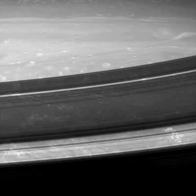 Cirrus-like clouds in the upper atmosphere of Saturn
A gorgeous close-up look at the Saturnian (upper) atmosphere reveals small, bright and puffy clouds with long filamentary streamers that are reminiscent of the anvil-shaped Earthly cirrus clouds that extend downwind of thunderstorms. Dark ring shadows hang over the scene while the Planet rotates beneath. 
The image was taken in infrared light (939 nnmts) with the Cassini spacecraft wide-angle camera on Oct. 29, 2005, at a distance of approximately 388.000 Km (roughly 241.000 miles) from Saturn. 
The image scale is 20 Km (about 12 miles) per pixel. 
The image was contrast enhanced to improve visibility of features in the atmosphere.

Parole chiave: Saturn - Atmosphere - upper layers