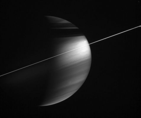 Saturn and Dione
In this magnificent view, delicate haze layers high in the atmosphere encircle the oblate figure of Saturn. A special combination of spectral filters used for this image makes the high haze become visible. A methane-sensitive filter (centered at 889 nnmts) makes high altitude features stand out, while a polarizing filter makes small haze particles appear bright. 
Methane in the atmosphere absorbs light with wavelengths around 889 nnmts as it travels deeper into the Gas Planet, thus bright areas in this image must represent reflective material at higher altitudes. 
Small particles or individual molecules scatter light quite effectively to a polarization of 90°, which this polarizing filter is sensitive to. Thus, high altitude haze layers appear bright in this view. 
The small blob of light at far right is Dione.

The image was taken with the Cassini spacecraft wide-angle camera on Dec. 5, 2005, at a distance of approx. 2,9 MKM (1,8 MMs) from Saturn and at a phase angle of 100°. The image scale is 169 Km per pixel.
Parole chiave: Saturn and Dione
