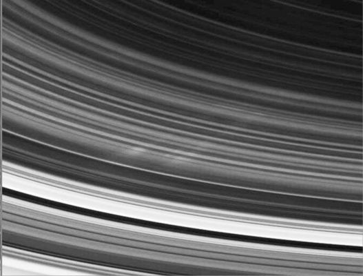 Spokes (2)
At the bottom left corner of the 1 st and 2nd image, the bright inner edge of the A-Ring is visible. Continuing radially inward (or toward Saturn) are several bands that lie within the Cassini Division, bounded by the bright outer edge of the B-Ring. The rounded shadow of Saturn cuts across the Rings in the image at right. 
Cassini's first sighting of Spokes occurs on the unilluminated side of the Rings, in the same region in which they were seen during the Voyager flybys. Although the most familiar Voyager images of spokes showed them on the sunlit side of the Rings, spokes also were seen on the unilluminated side. 
In Voyager images, when Spokes were seen at low phase angles, they appeared dark; when seen at high phase angles, they appeared bright. The Spokes seen here are viewed by Cassini at a very high phase angle, which is about 145° at the center of each image.
Parole chiave: Saturn's Rings - Spokes